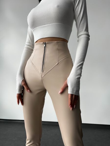 Women's leggings made of eco leather on fleece with a high fit, color beige.