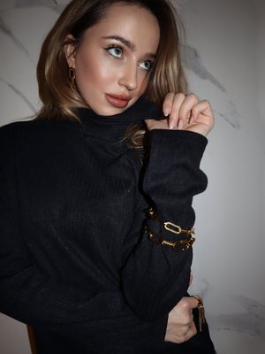 Black sweater made of free cut knitwear with a high collar and long sleeve
