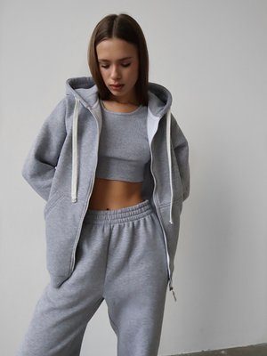 Warm women's sports suit with joggers and an elongated jacket with a zipper.