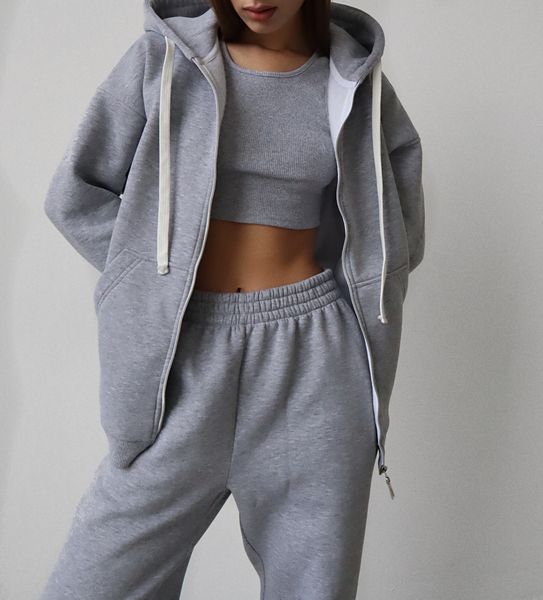 Warm women's sports suit with joggers and an elongated jacket with a zipper.