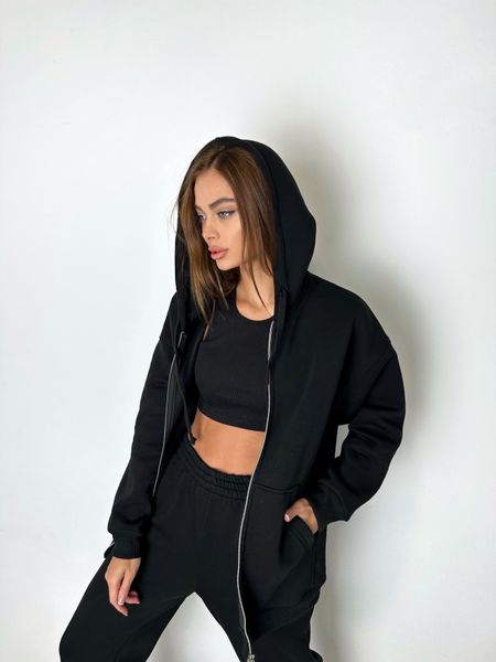 Warm women's sports suit with joggers and an elongated jacket with a zipper.