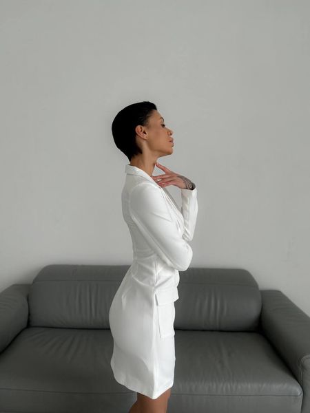 Dress-jacket in white with an ingenious neckline and patch pockets.