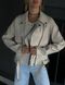Women's leather jacket with high quality eco-leather suede with metal zipper and buttons in ivory color.