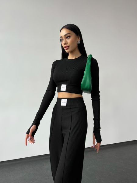 Fashion women's lightweight ribbed knitted suit with wide leg pants and long sleeve top.