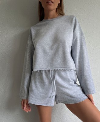 casual women's suit with shorts and a sweatshirt made of natural fabric.