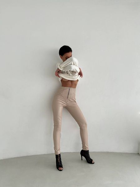 Women's leggings made of eco leather on fleece with a high fit, color beige.