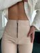 Women's leggings made of eco leather on fleece with a high fit, color beige.